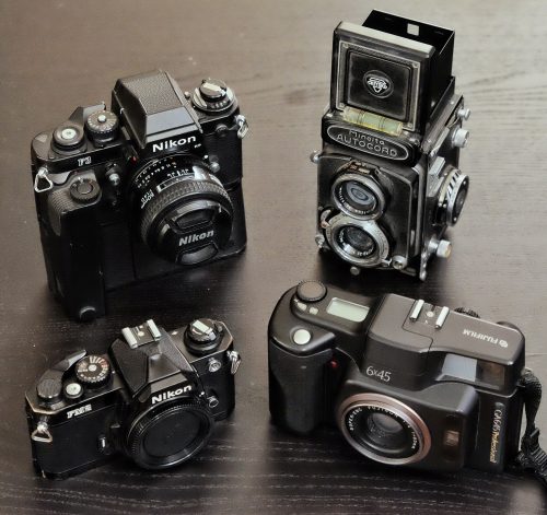 A collection of film cameras as described in the caption below
